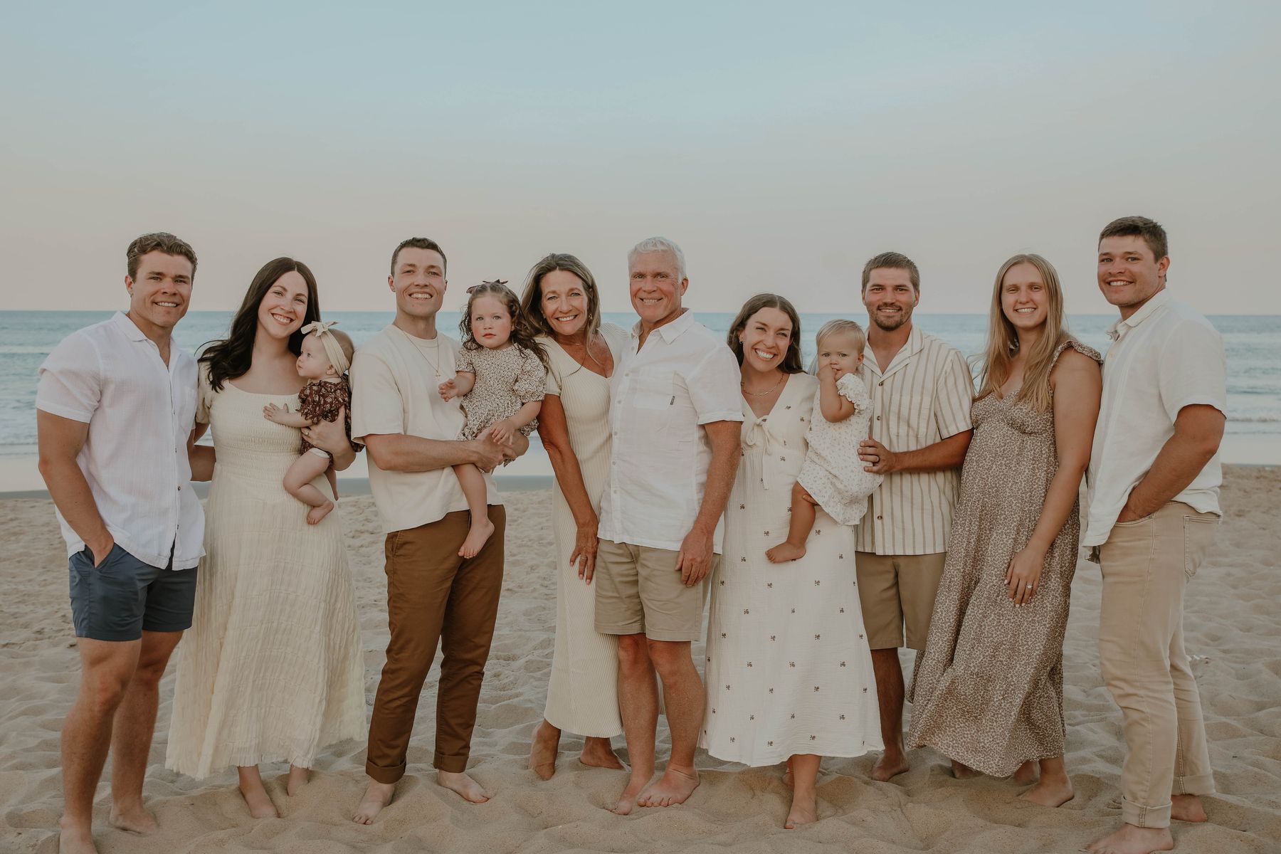 The whole family standing on the beach