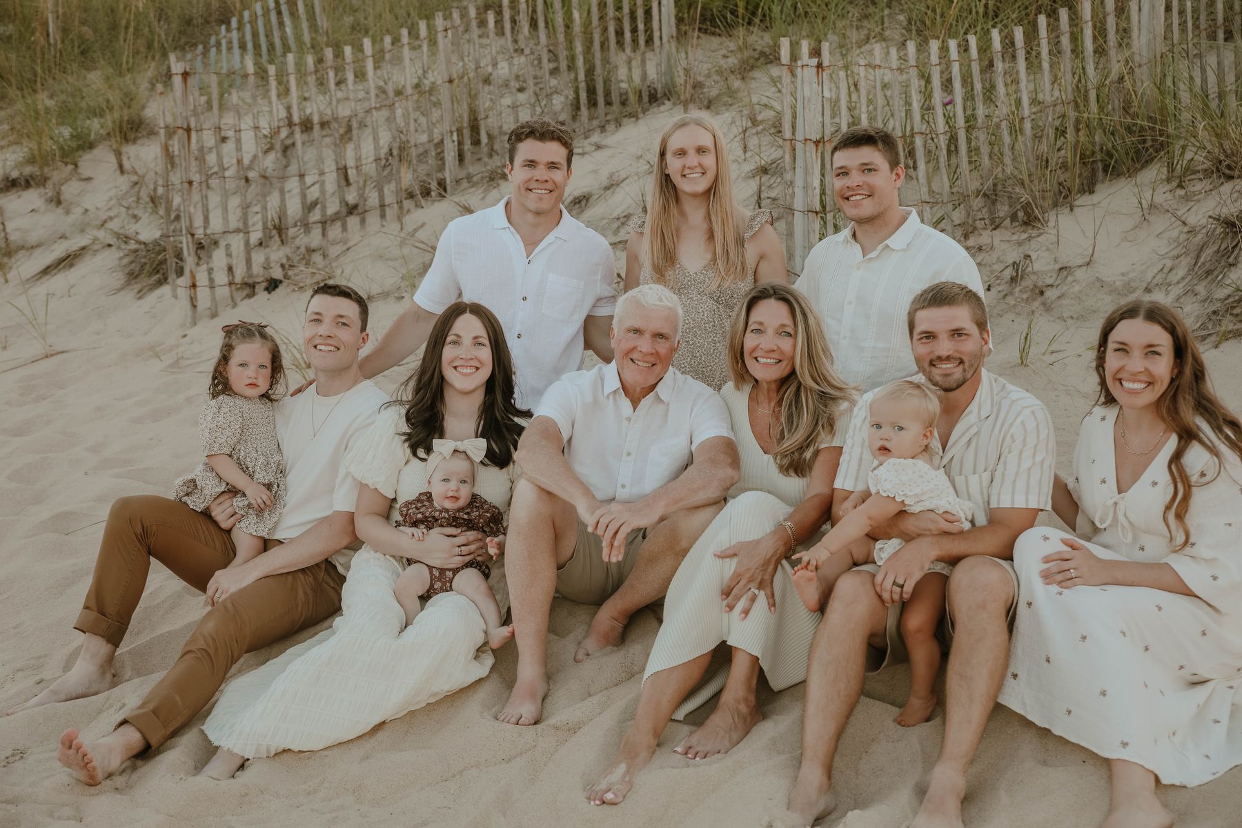 The whole family sitting against the dune fence