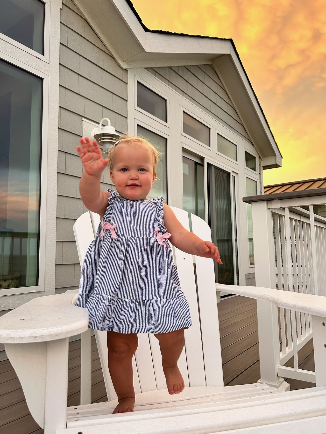 Waving from the Adirondack chair at sunset