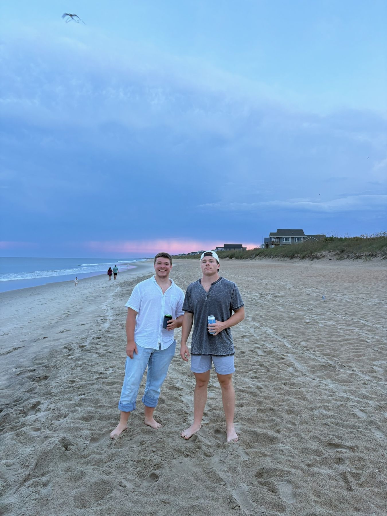 Standing around on the beach at dusk