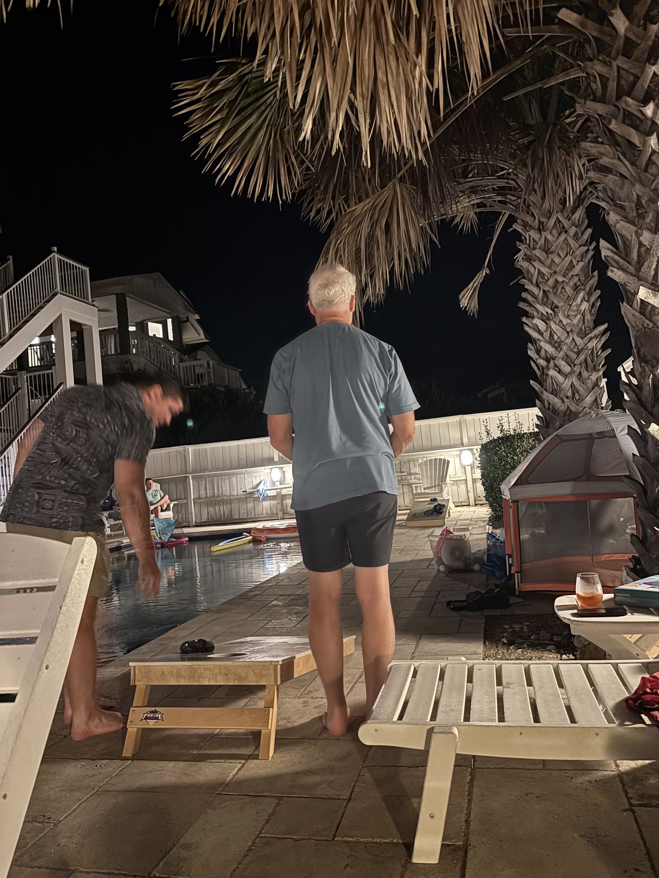 Cornhole by the pool at night