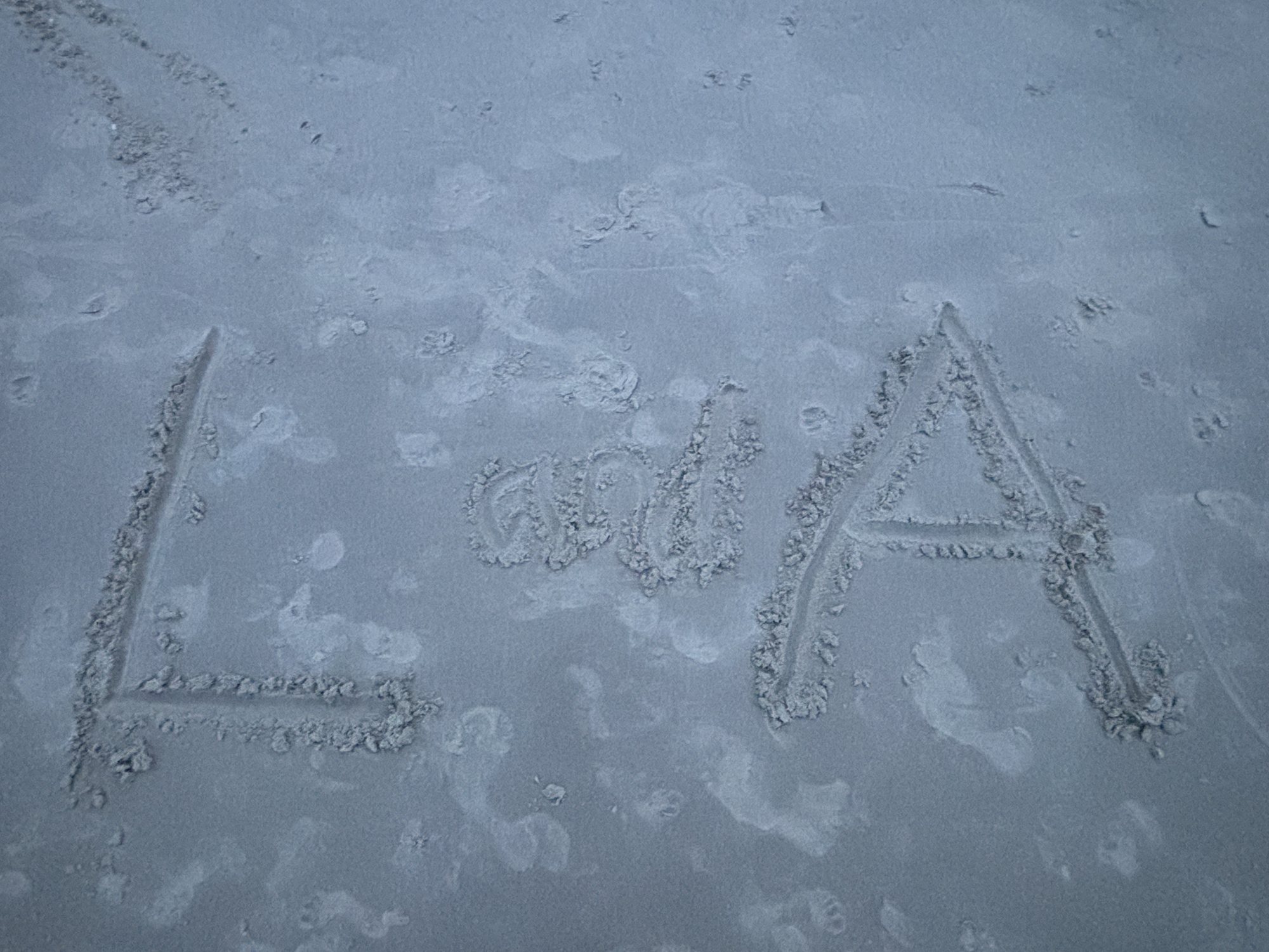 L and A written in the sand