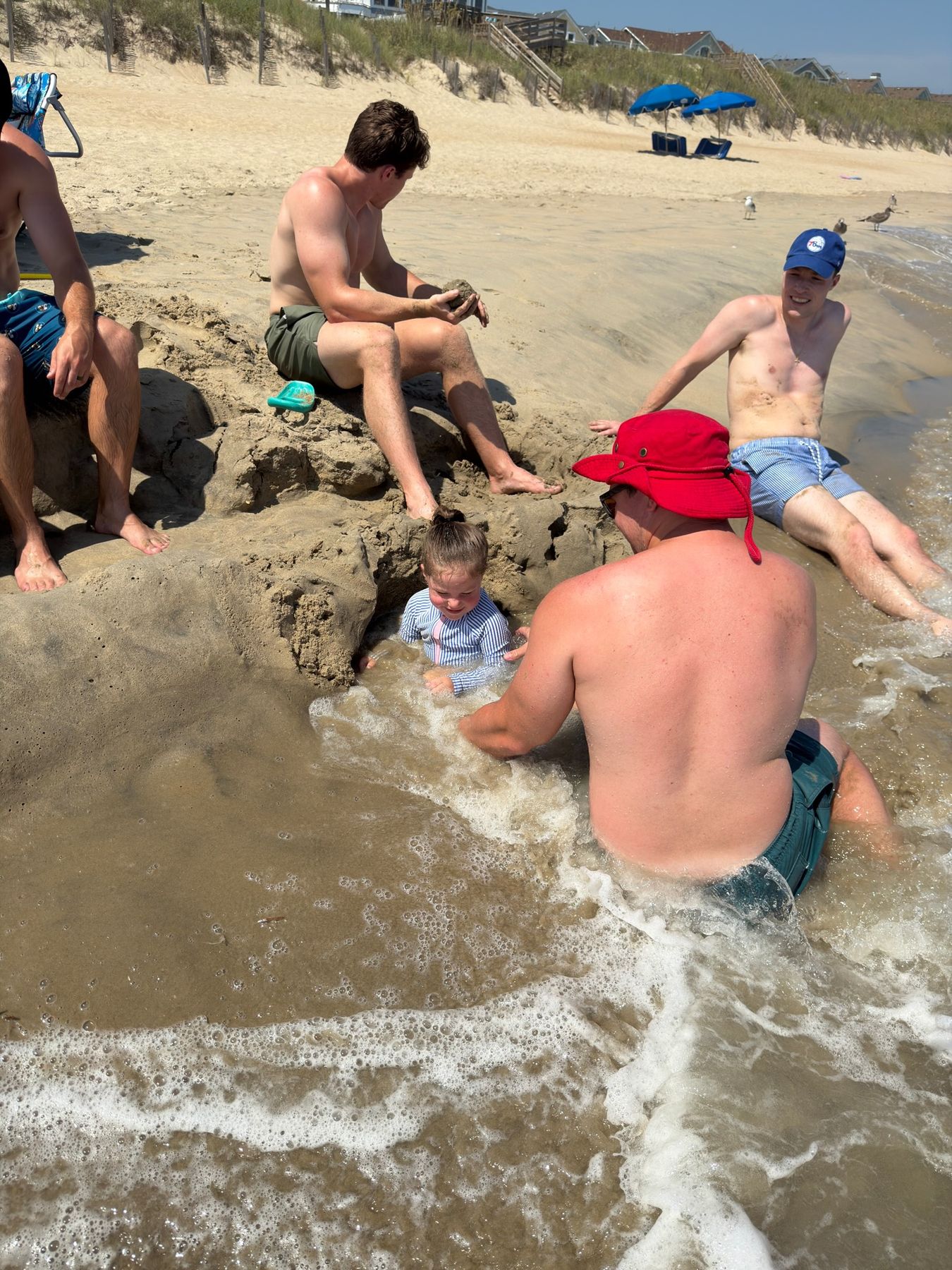 A wave floods the sand pit